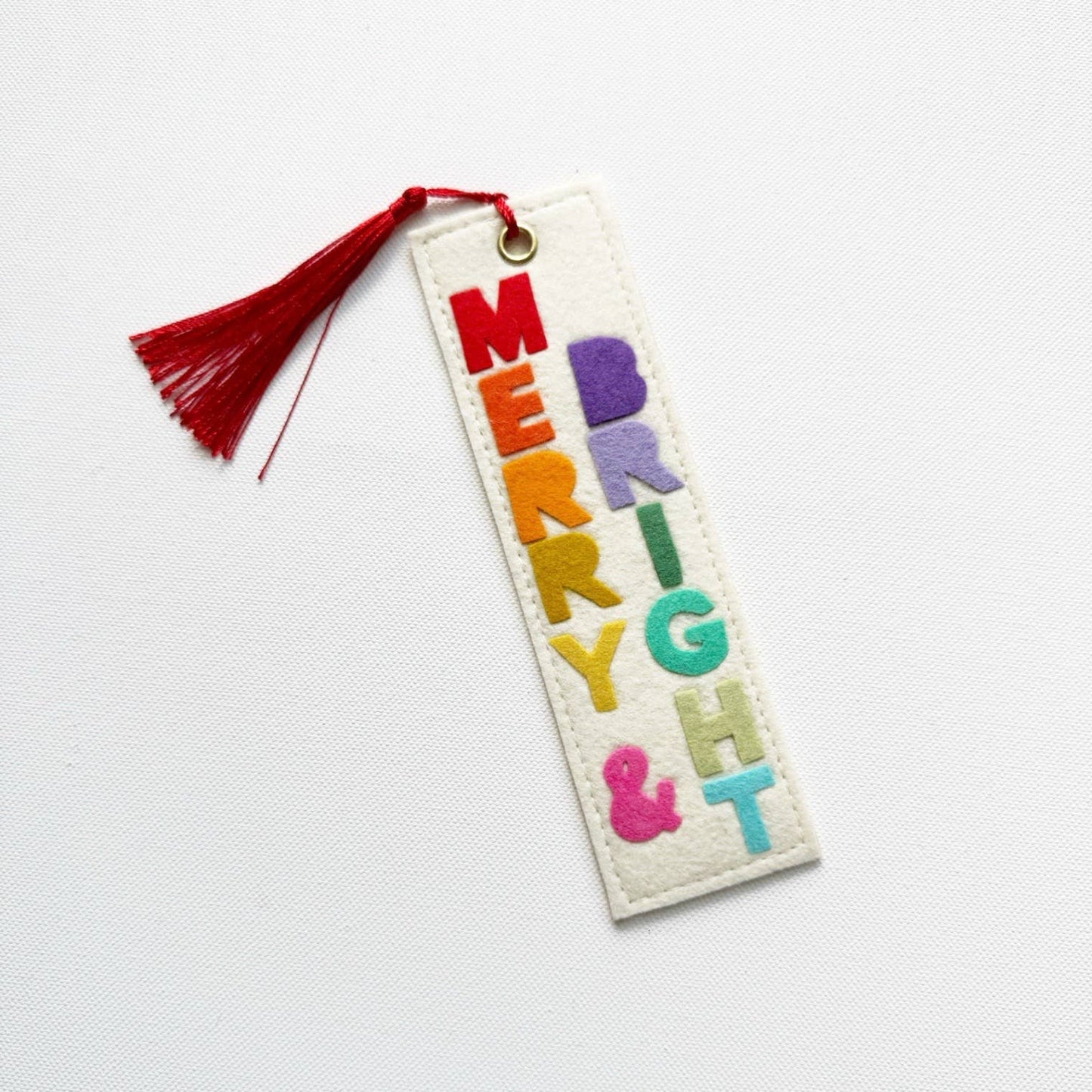 Colorful embroidered bookmark with tassel on a white background