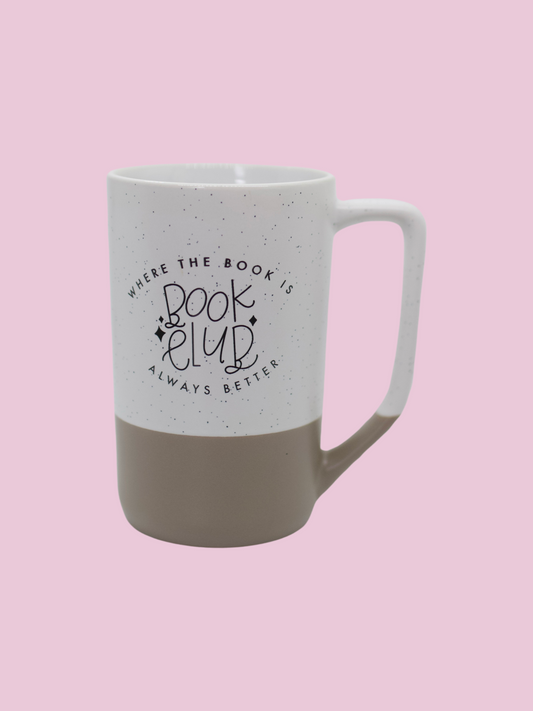 A two-tone ceramic mug with the upper part white with black speckles and the lower part taupe, featuring 'Book Club' text imprinted on the white part.