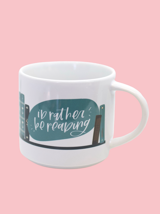 Glossy white mug with 'i'd rather be reading' and book graphic print wrapped around the mug