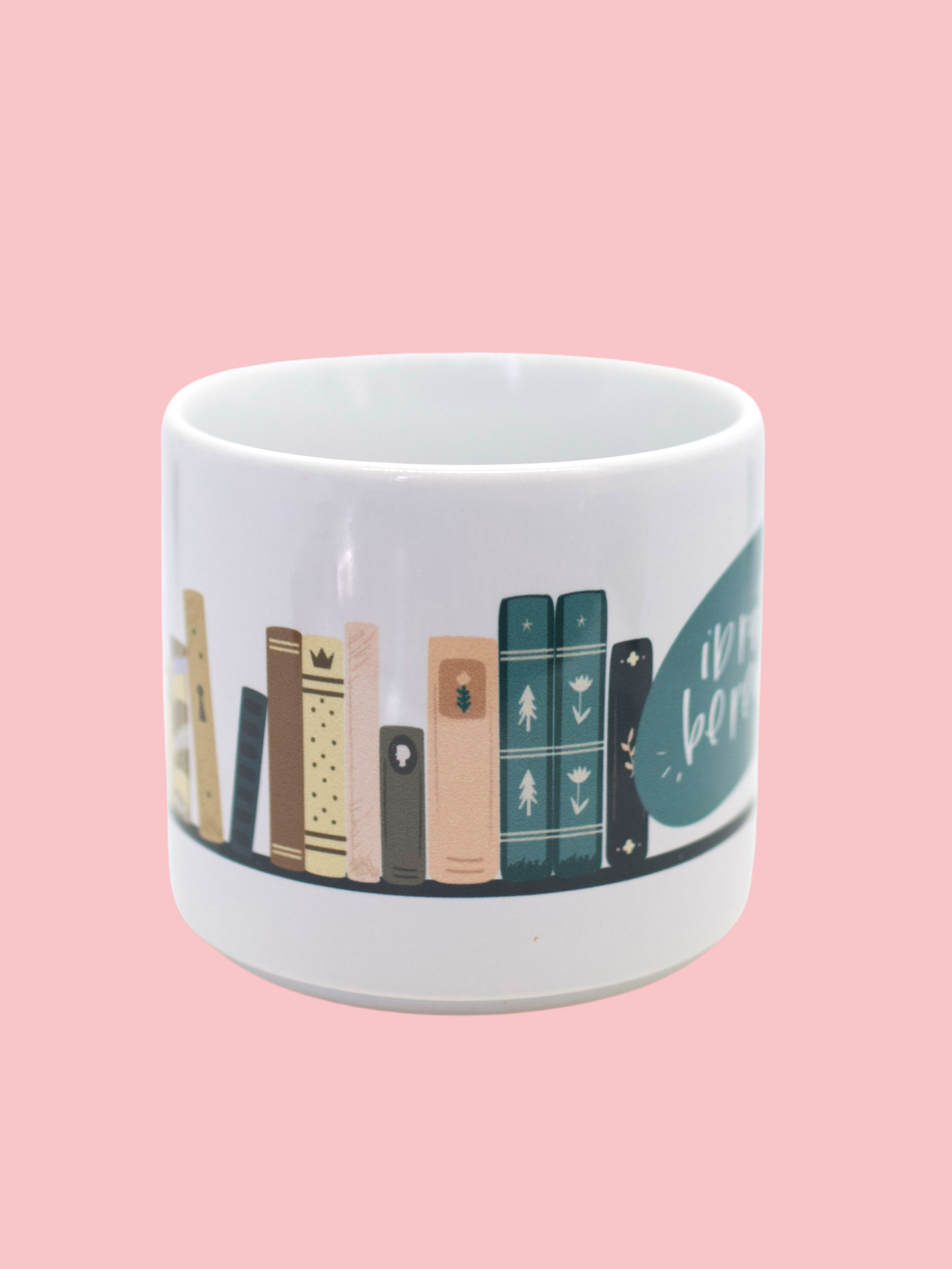 Glossy white mug with 'i'd rather be reading' and book graphic print wrapped around the mug