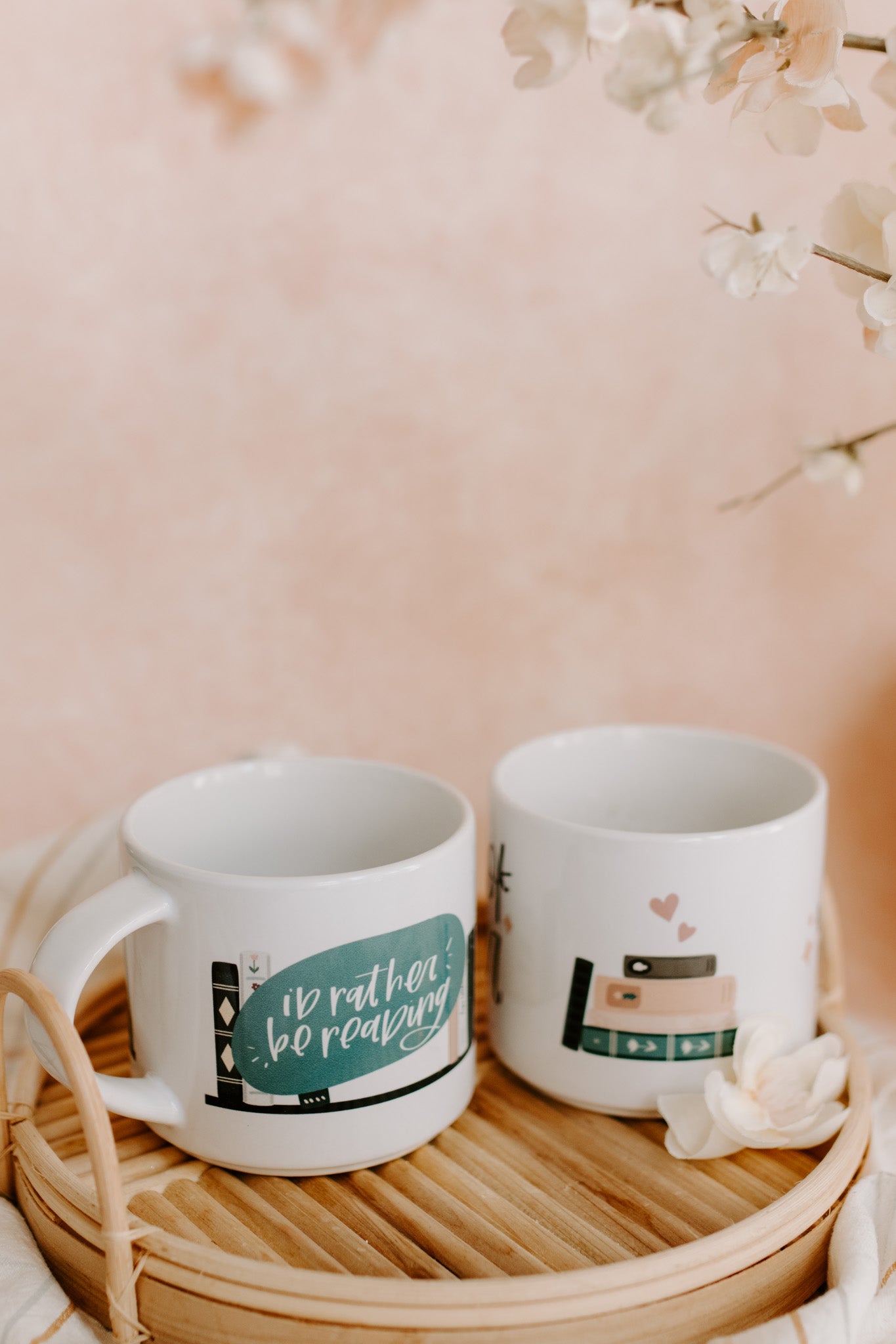Glossy white mug with 'i'd rather be reading' and book graphic print wrapped around the mug