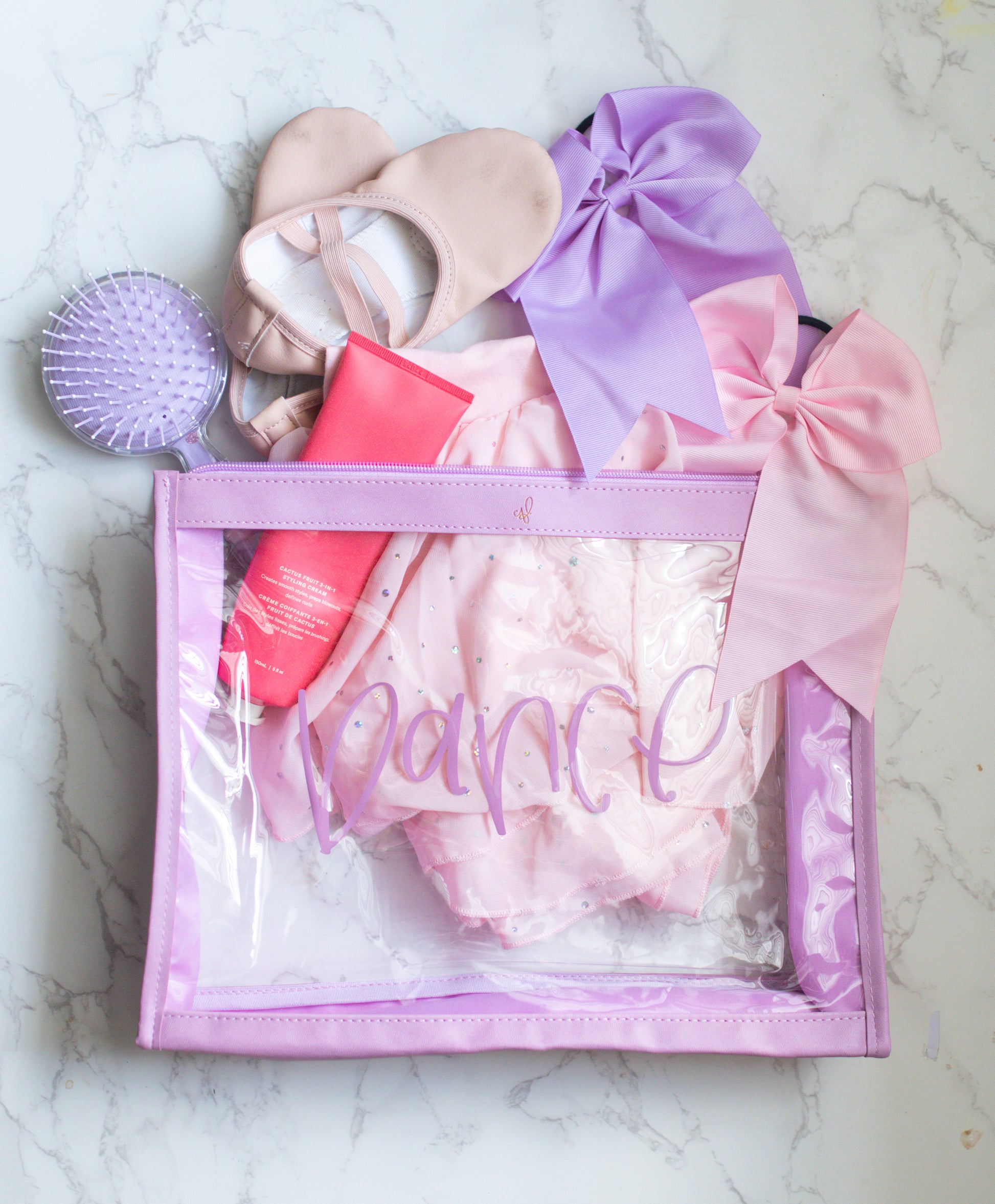 A clear plastic organizer pouch with lavender trim, labeled 'Dance' on the front.