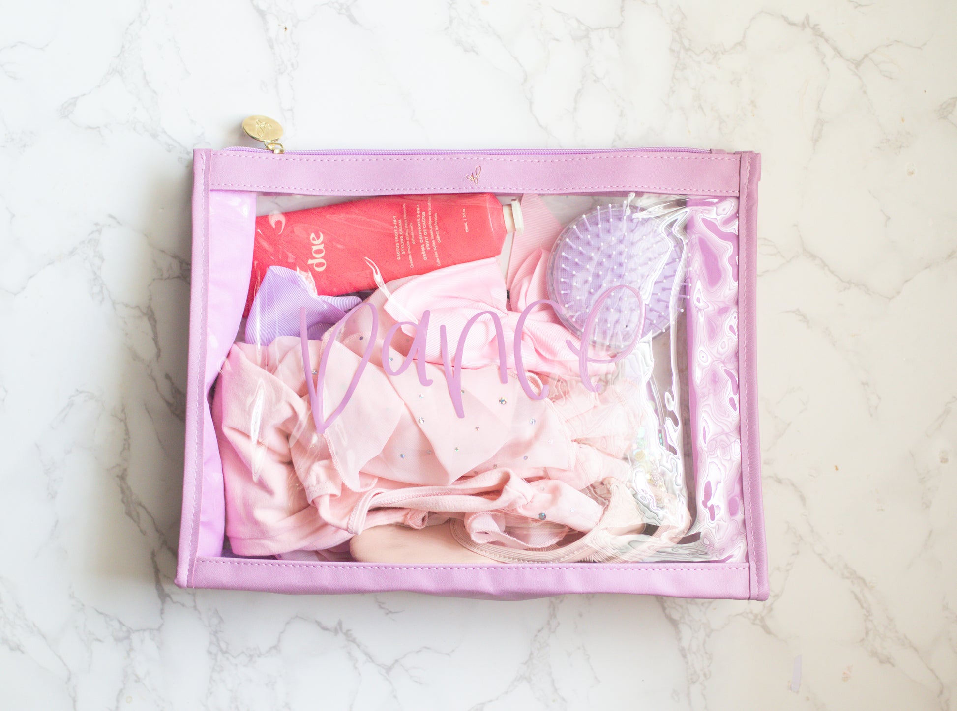 A clear plastic organizer pouch with lavender trim, labeled 'Dance' on the front.