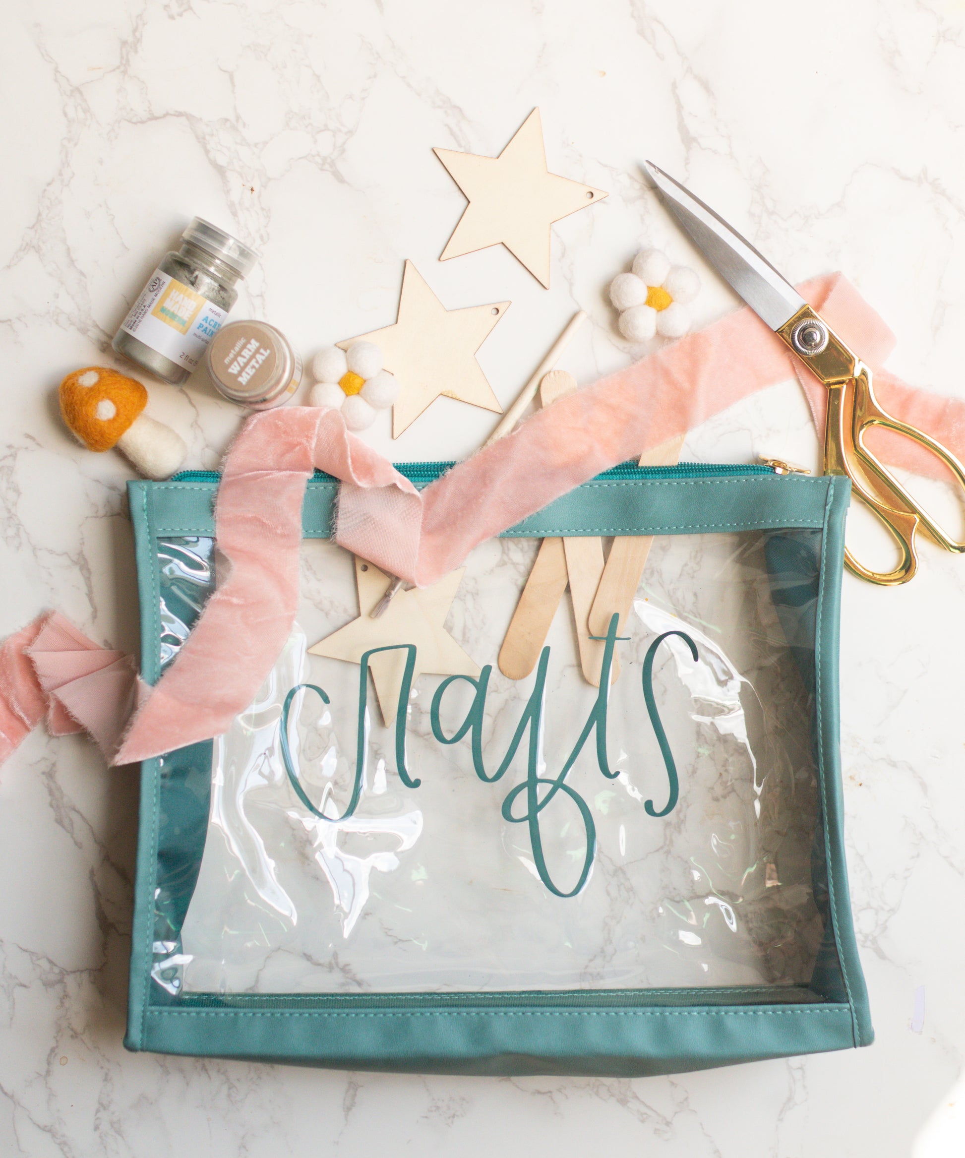 A clear vinyl organizer pouch with teal trim, labeled 'crafts' on the front, designed to hold various craft materials.