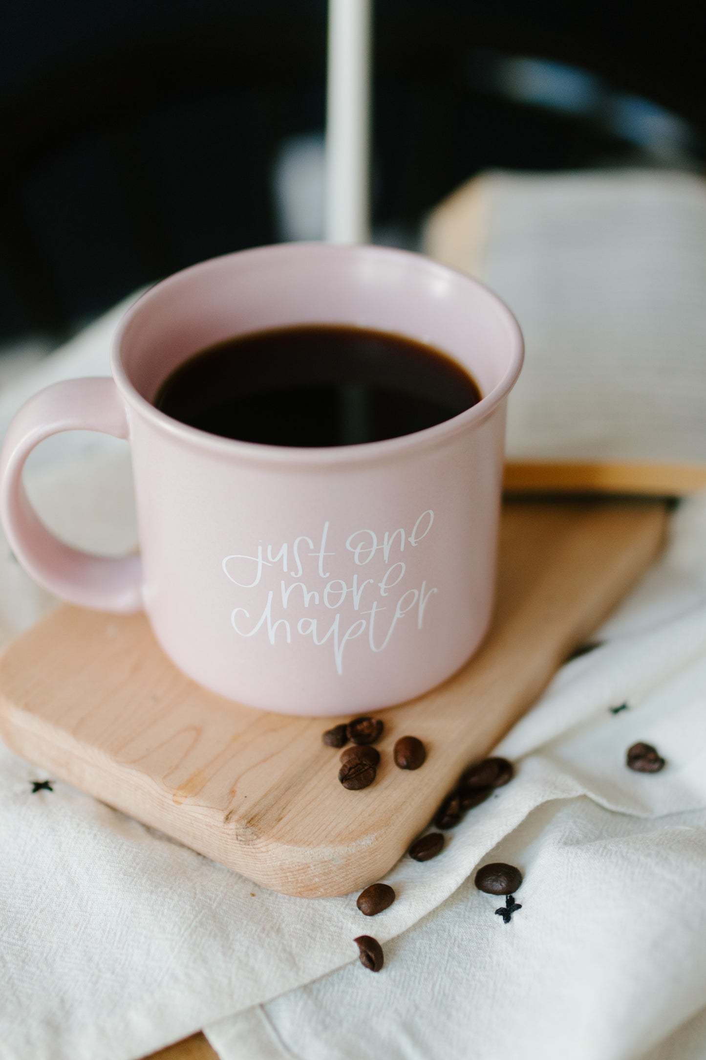 A matte lilac ceramic mug with the phrase 'Just One More Chapter' printed in white on the side.