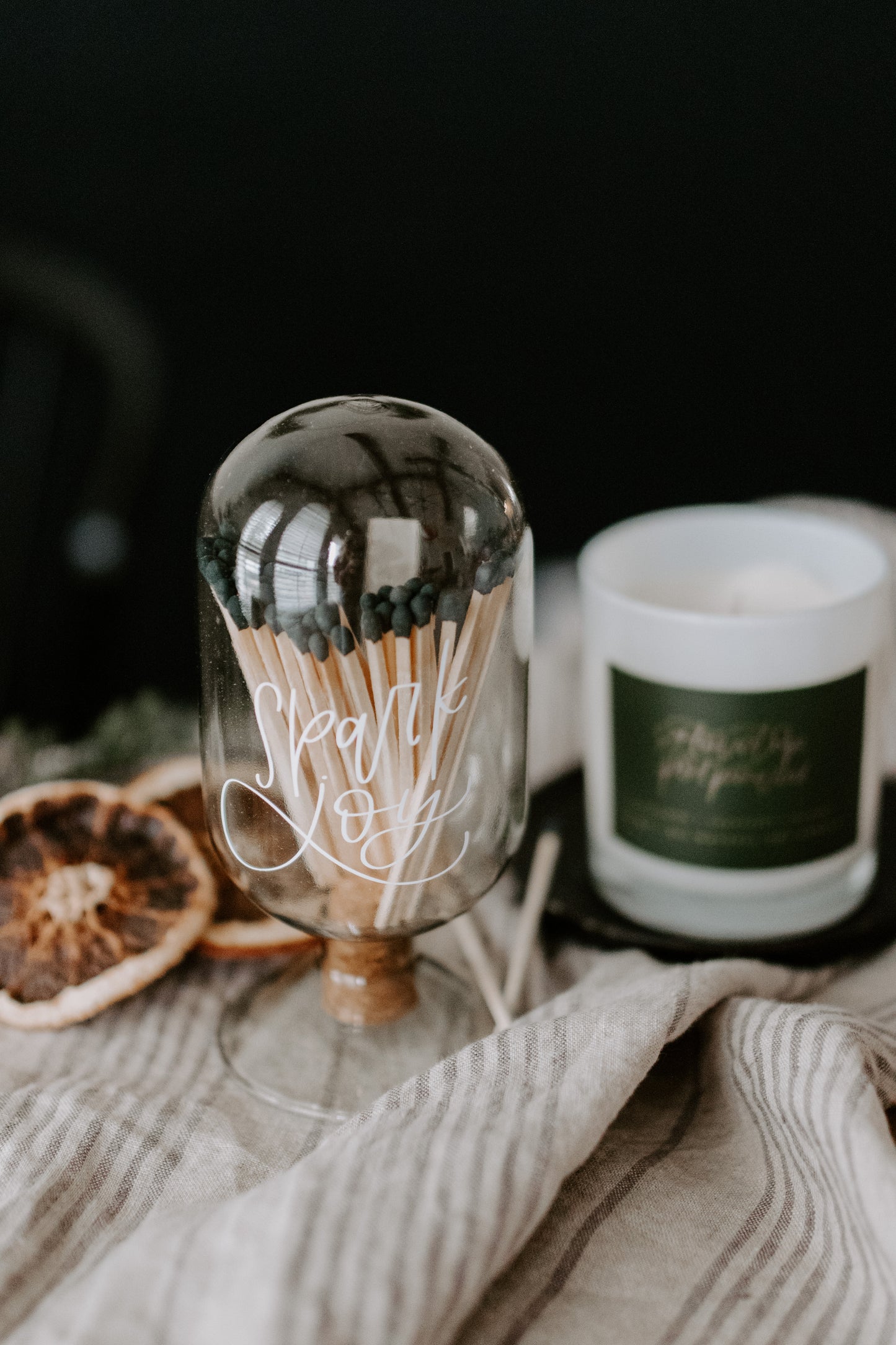 Glass Cloche with 'Spark Joy' hand lettered font in white with matches inside with cork covered hole on bottom