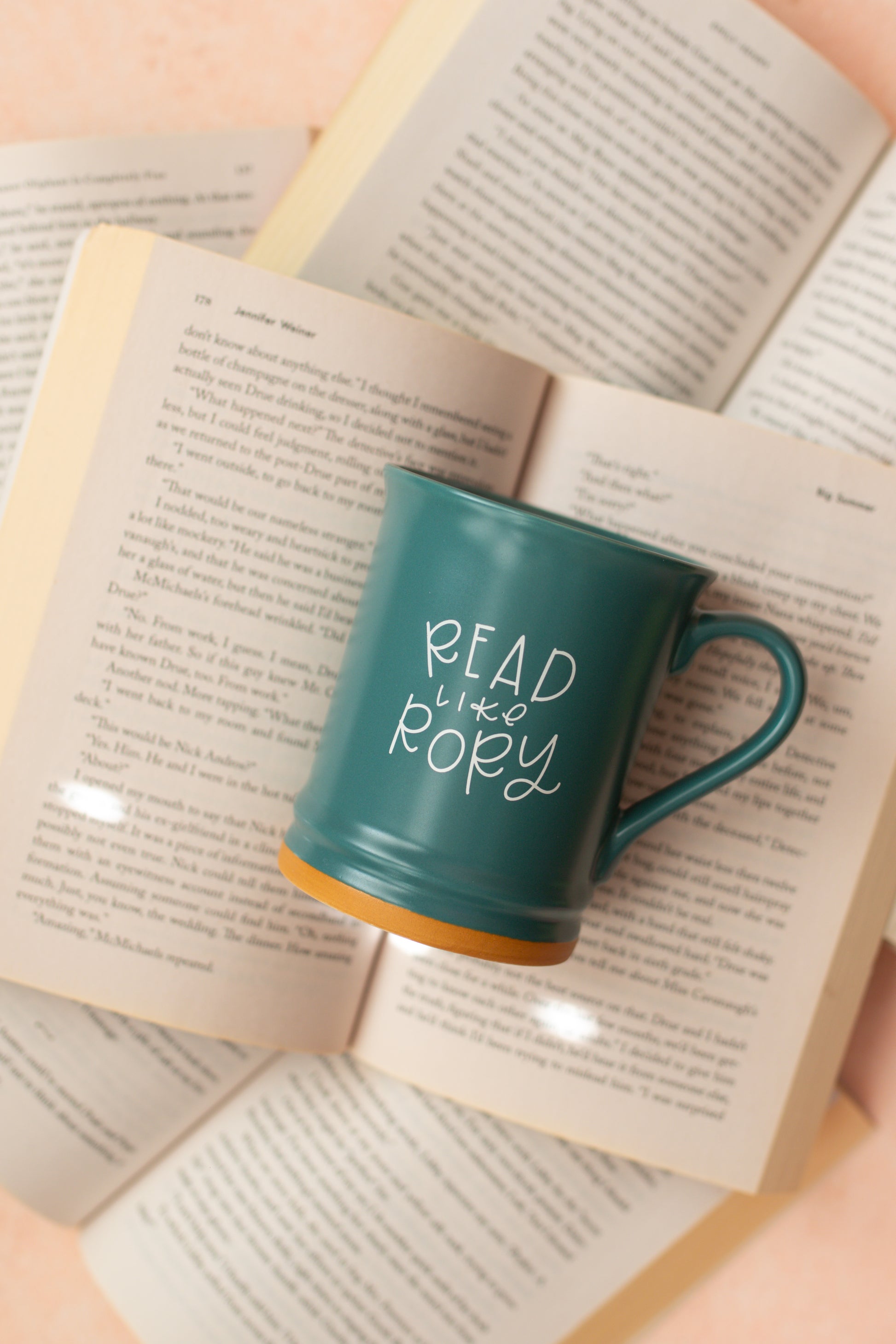 A matte teal ceramic mug with 'READ LIKE RORY' printed in white on the side.