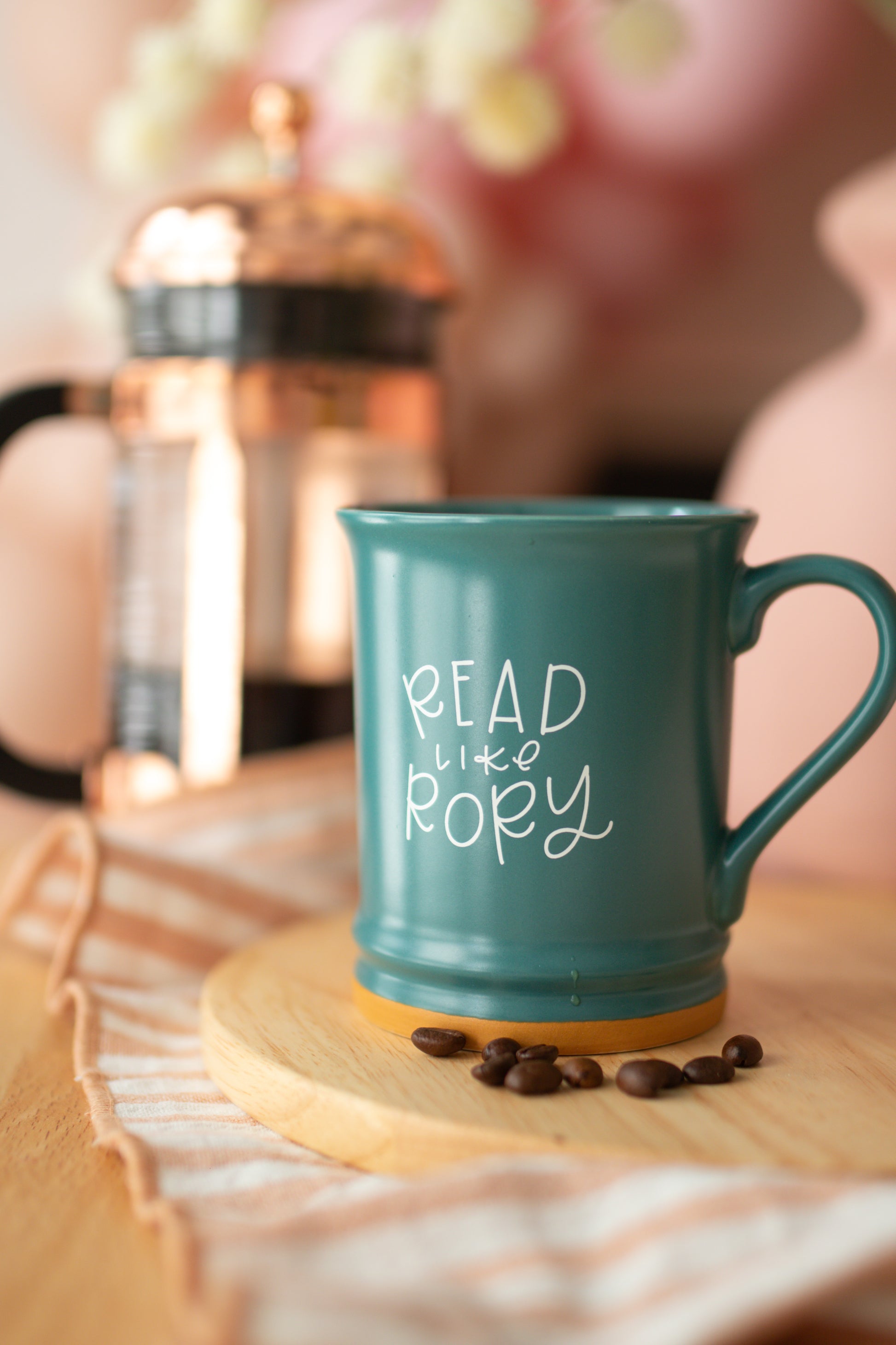 A matte teal ceramic mug with 'READ LIKE RORY' printed in white on the side.