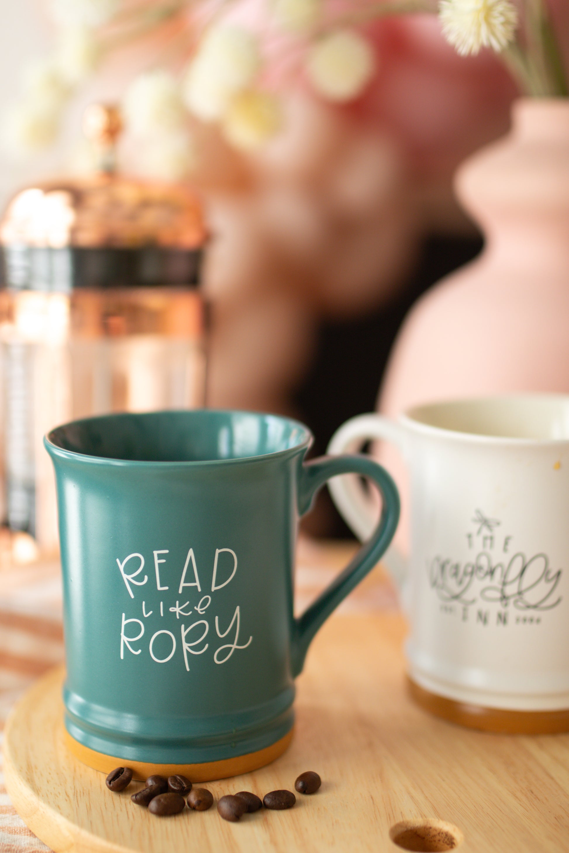 A matte teal ceramic mug with 'READ LIKE RORY' printed in white on the side.