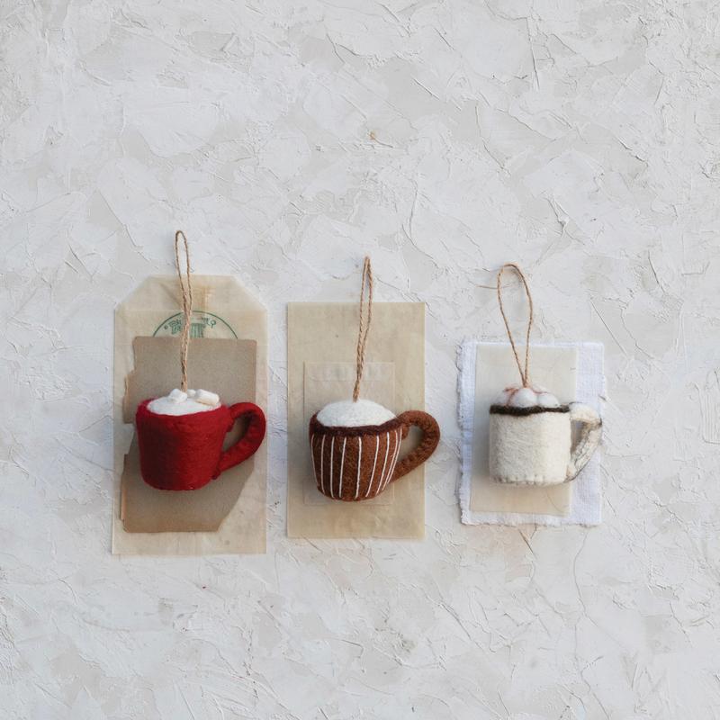 Three handmade wool felt mug ornaments in red, silver, and brown colors, each with a cup design and embroidery details.