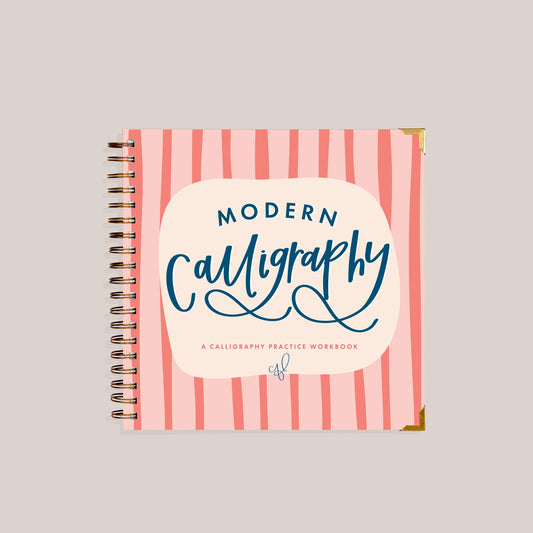 Calligraphy practice workbook with pink striped cover on a light gray background