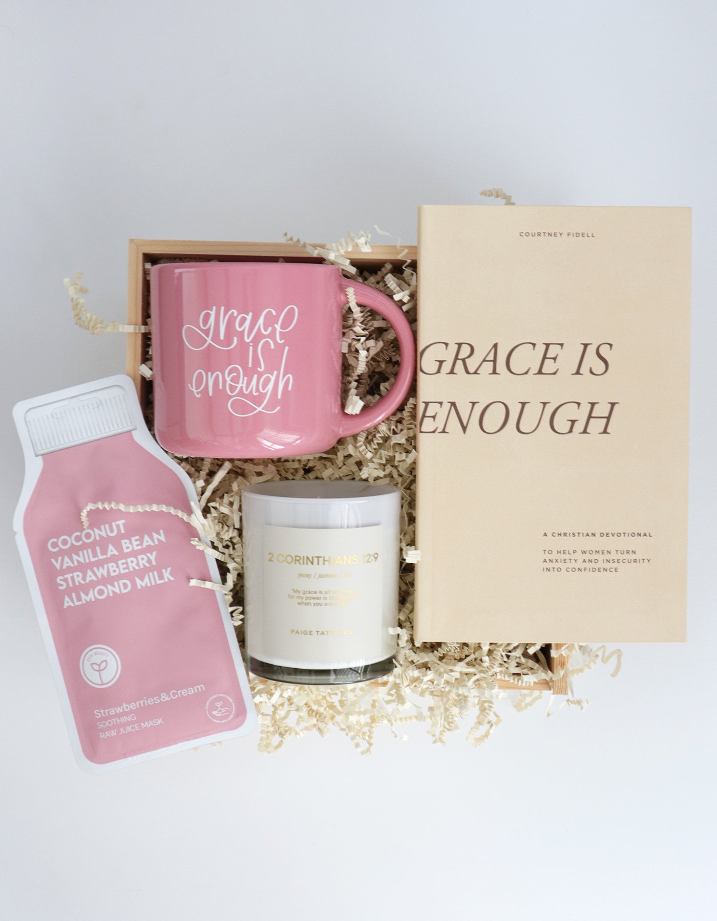 Gift set with pink mug, coconut milk carton, and candle in a box with 'Grace is Enough' theme.