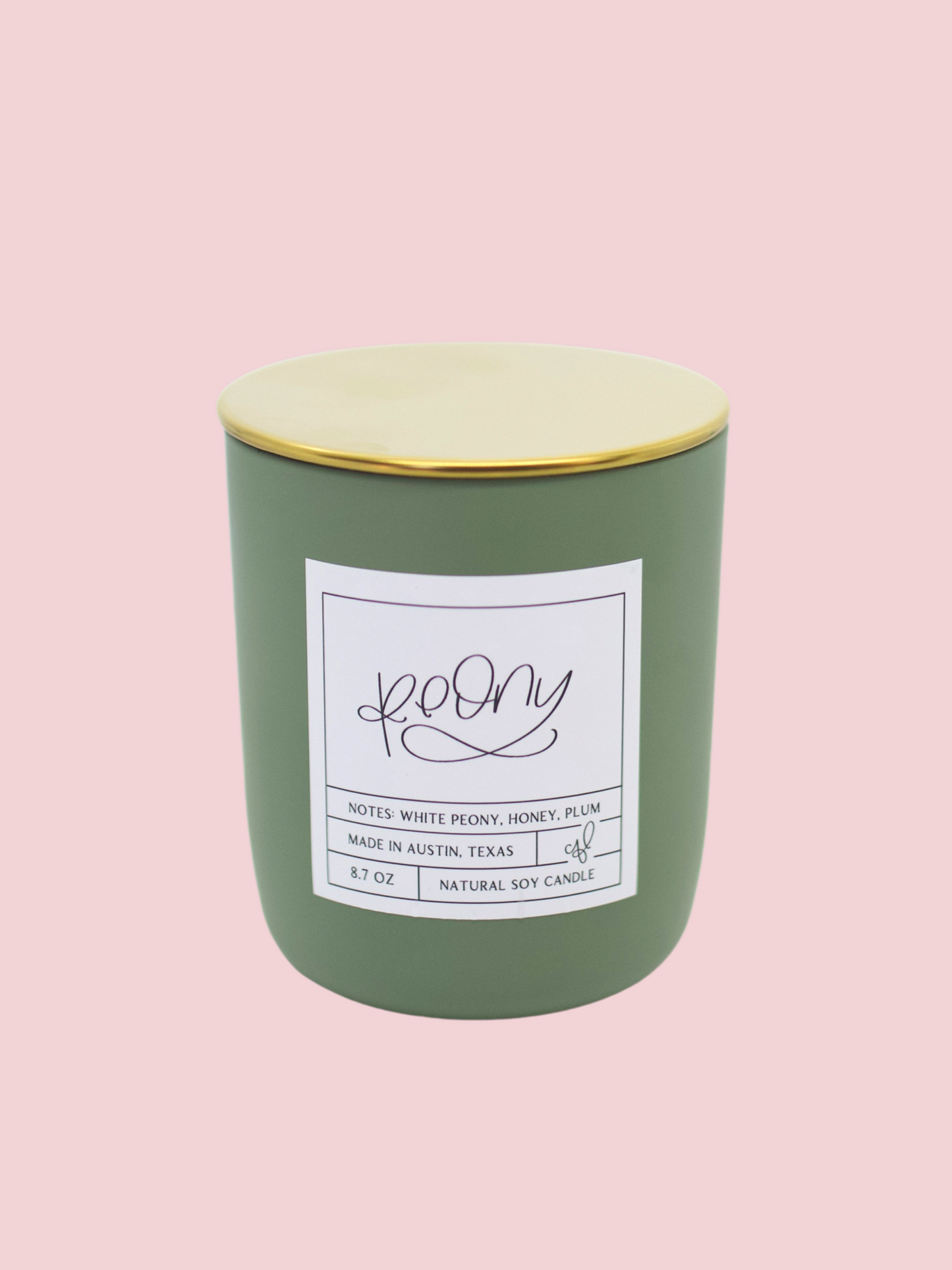 Green candle with a gold lid with peony scent