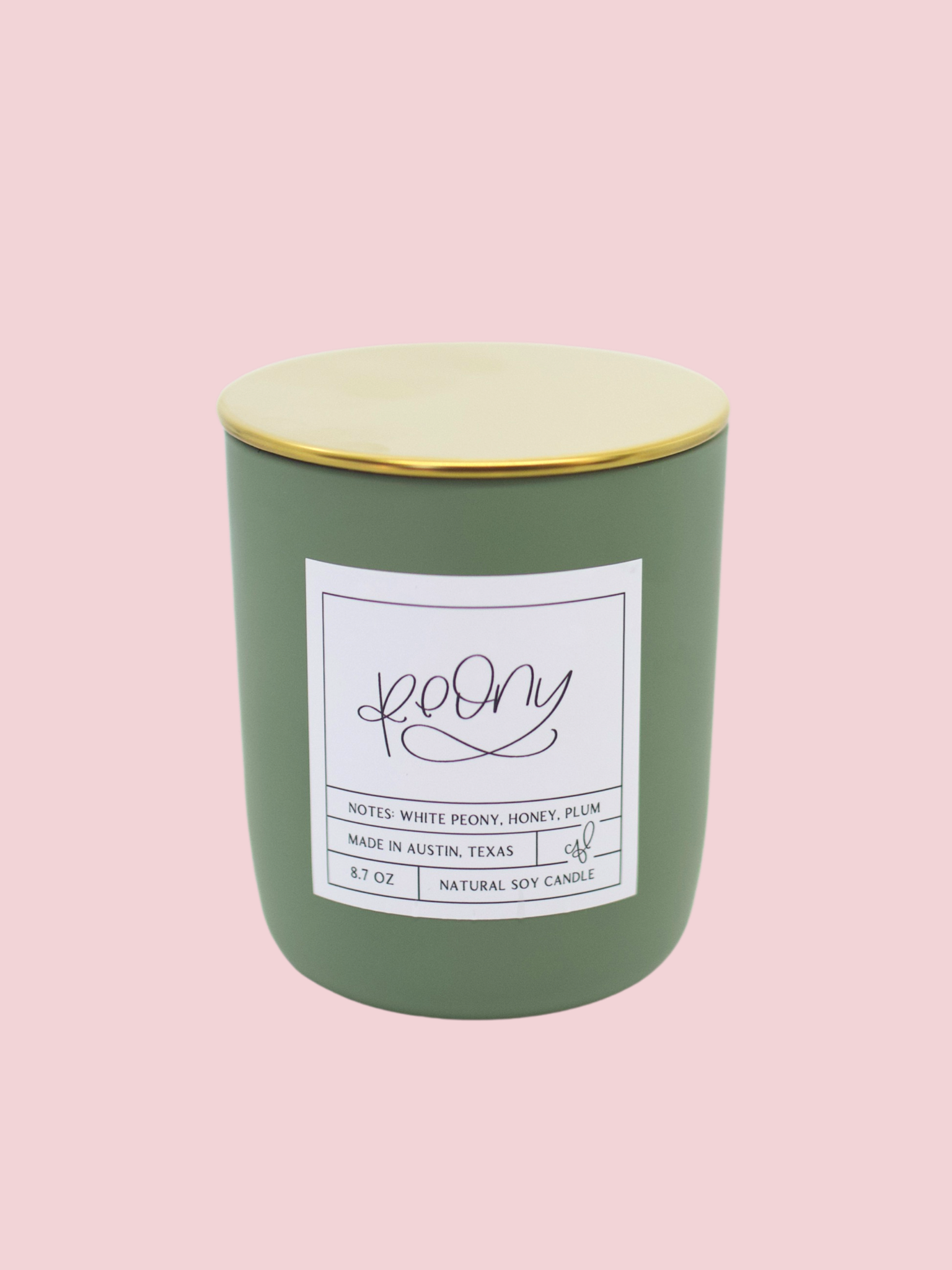 Green candle with a gold lid with peony scent