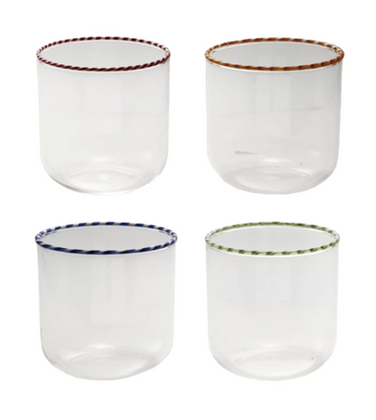 Four clear glass tumblers with colored rims on a white background