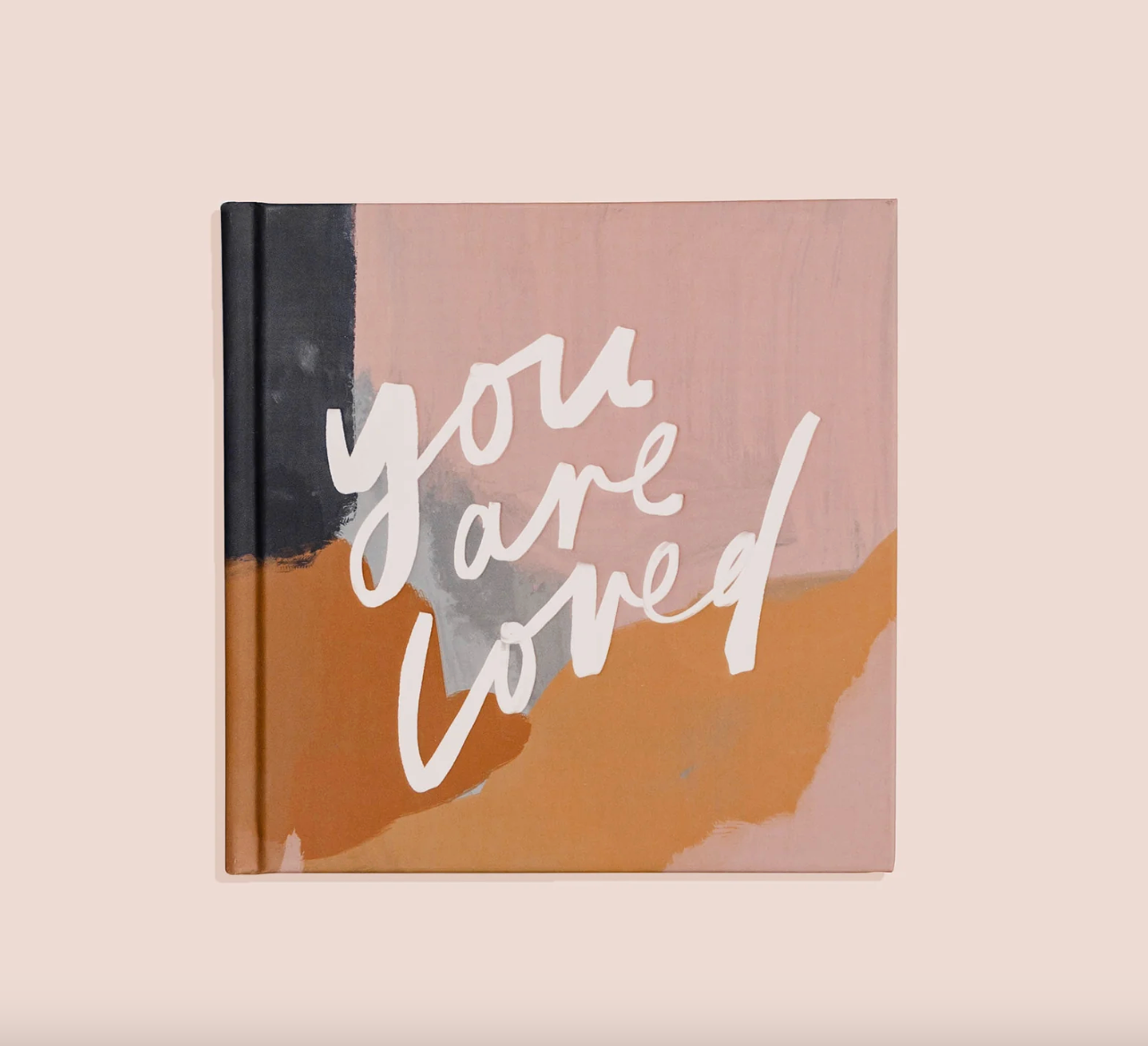 Book with 'you are loved' text on a abstract design cover