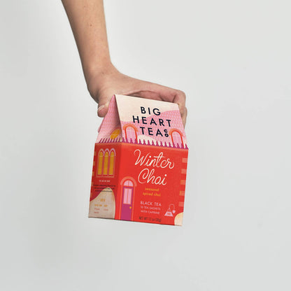 Person holding a box of Big Heart Teas Winter Chai tea against a plain background