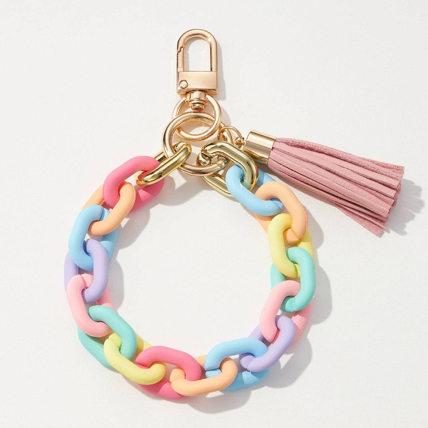 Colorful chain keychain with a pink tassel on a light gray background