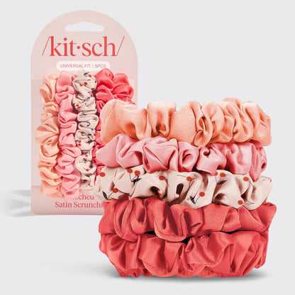 Set of pink satin scrunchies with packaging labeled 'kitsch' on a light gray background